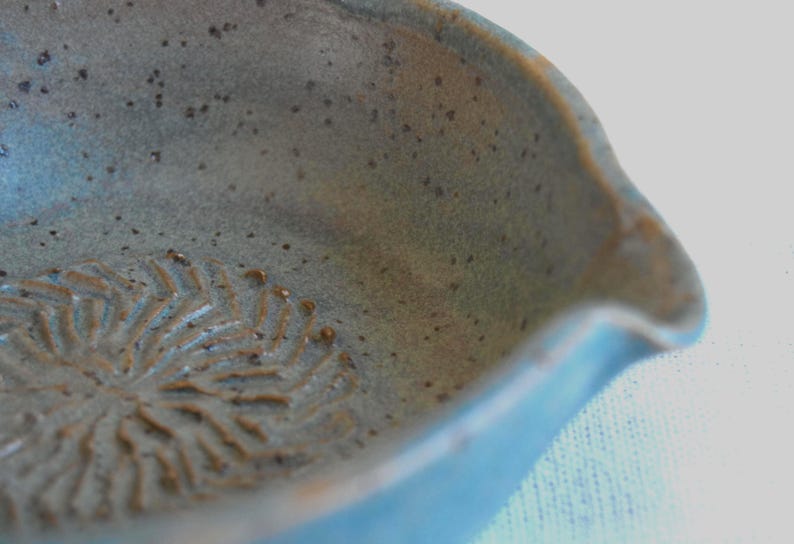 Greenish blue garlic grater plate with herb stripper and spout in matte speckled finish