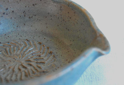 Greenish blue garlic grater plate with herb stripper and spout in matte speckled finish